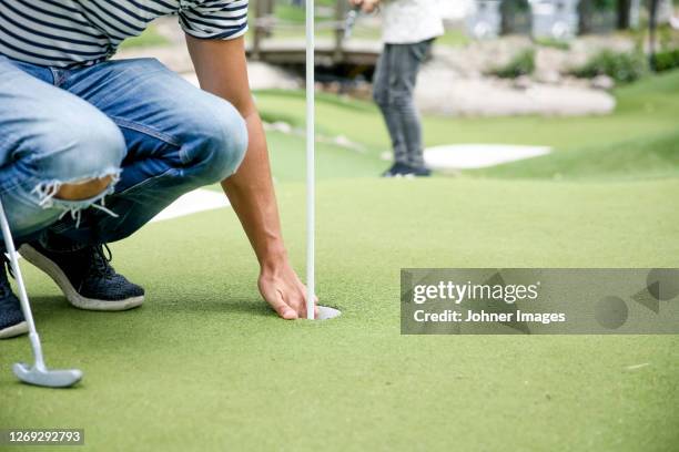 man playing mini golf - mini golf stock pictures, royalty-free photos & images