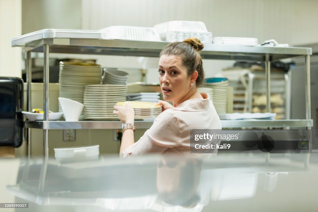 Hispanic woman working in restaurant