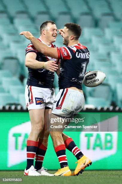 Brett Morris of the Roosters celebrates with James Tedesco of the Roosters after scoring a try during the round 16 NRL match between the Sydney...