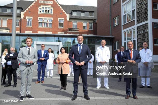 Hospital Director Ralf Engels, German Health Minister Jens Spahn and North Rhine-Westphalia Governor Armin Laschet pose before visiting a tent used...