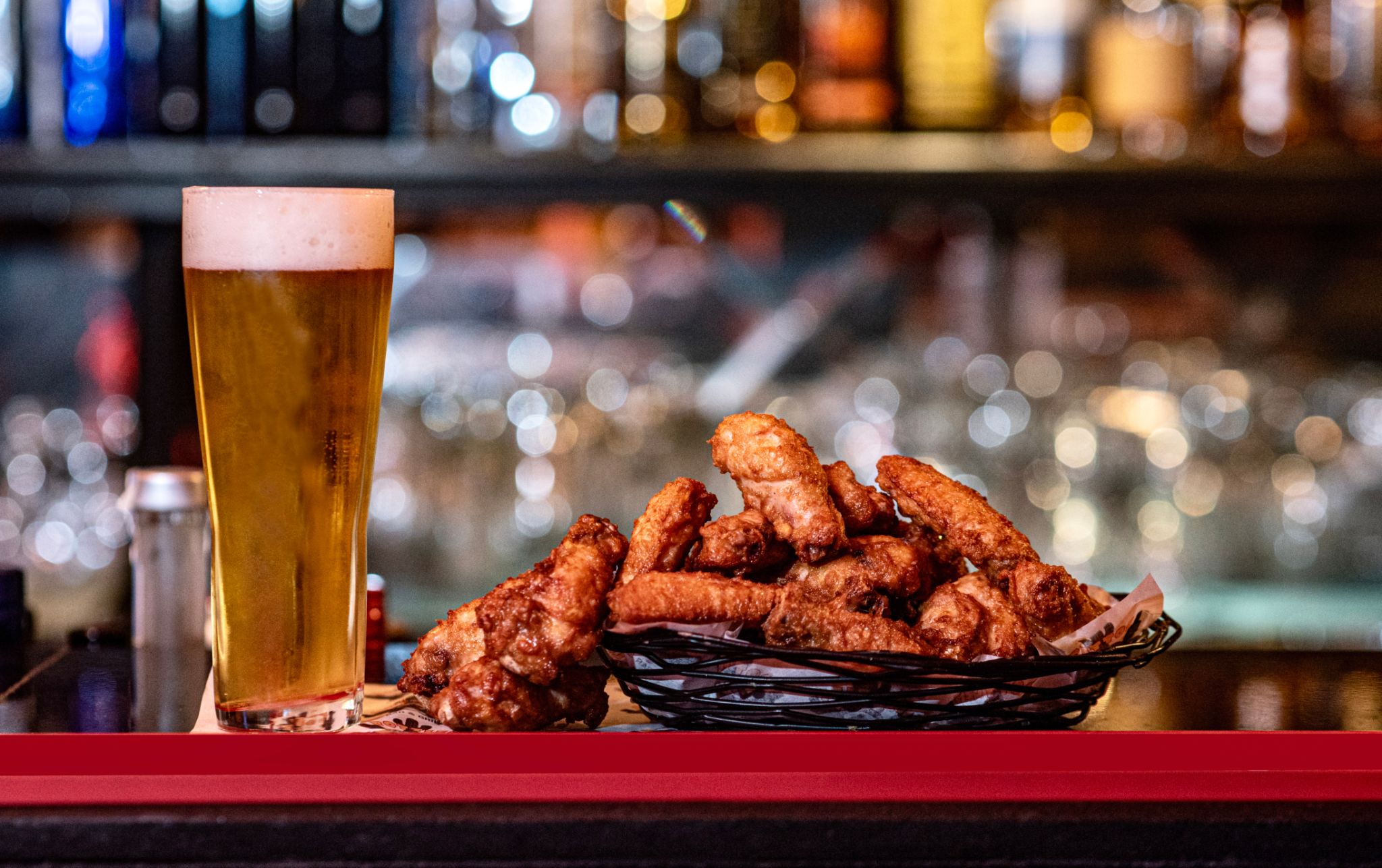 A plate of a beer and chicken wings A plate of a beer and chicken wings
