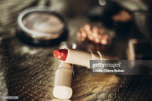 bright lipstick in a light tube with other cosmetics - backstube stock pictures, royalty-free photos & images