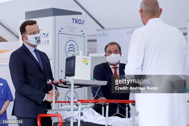 German Health Minister Jens Spahn and North Rhine-Westphalia Governor Armin Laschet talk to Head physician pneumology Thomas Voshaar during a visit...