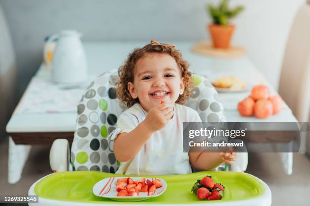 child eating strawberry for breakfast, healthy and vegan eating concept - baby eating stock pictures, royalty-free photos & images