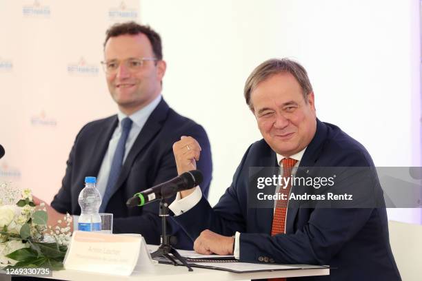 German Health Minister Jens Spahn and North Rhine-Westphalia Governor Armin Laschet speak to medical personel after visiting a tent used for...