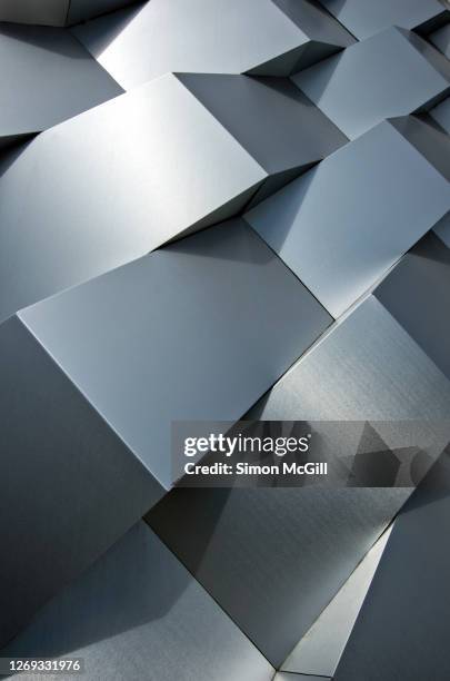 futuristic angular brushed stainless steel cladding on a building - brushed steel stock pictures, royalty-free photos & images