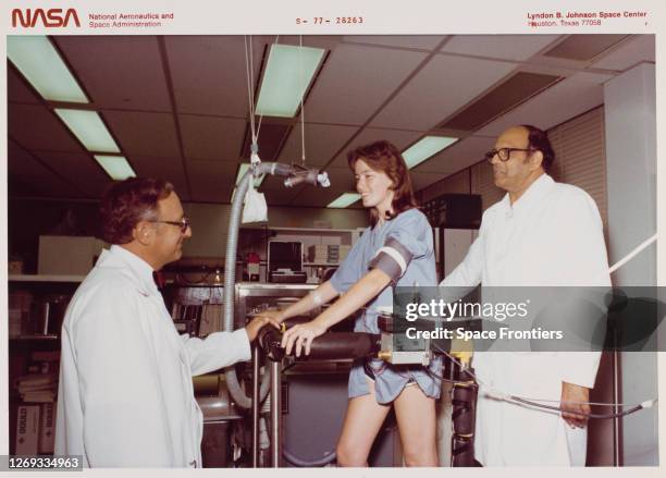 American chemist and NASA astronaut candidate Anna Lee Fisher is observed by Dr John F Ziegelschmid , of the JSC's Medical Sciences Division, and...