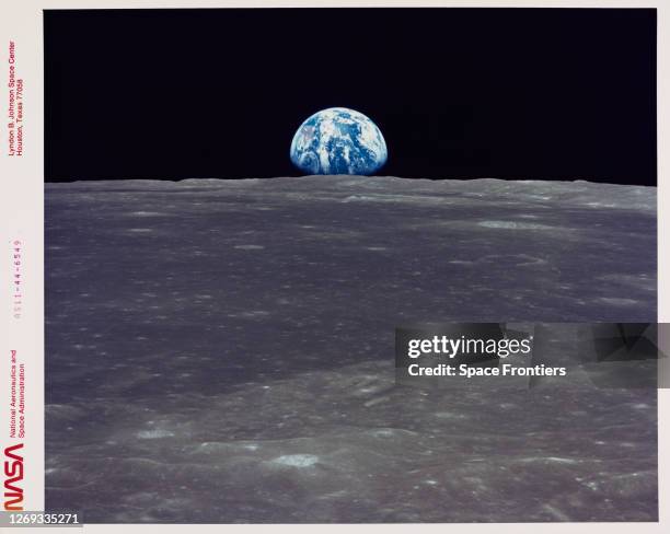 The Earth rises above the Moon's horizon, the lunar terrain is in the area of Mare Smythii on the nearside, in an image taken by Apollo 11, July...