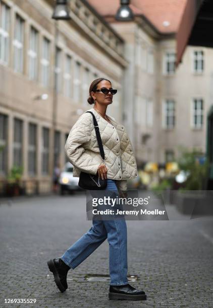 Anna Winter wearing Levis jeans, Prada bag and boots, Weekday jacket and Valentino shades on August 27, 2020 in Berlin, Germany.