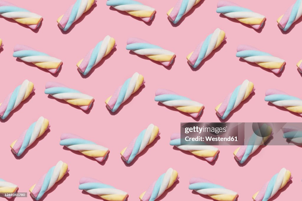 Pattern of marshmallows against pink background