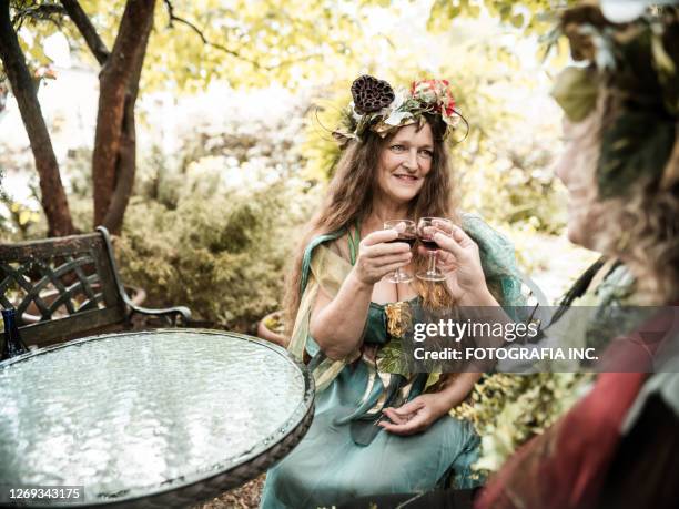 two girlfriends having a drink of vino - cosplay disney stock pictures, royalty-free photos & images