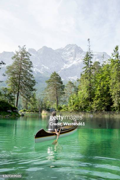 canoeist on lake eibsee, bavaria, germany - baviera foto e immagini stock