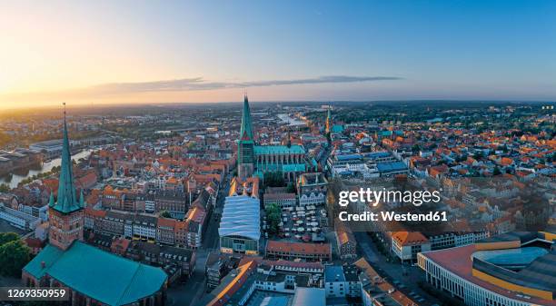 germany, schleswig-holstein, lubeck, aerial view of old town at sunset - travemuende stock pictures, royalty-free photos & images