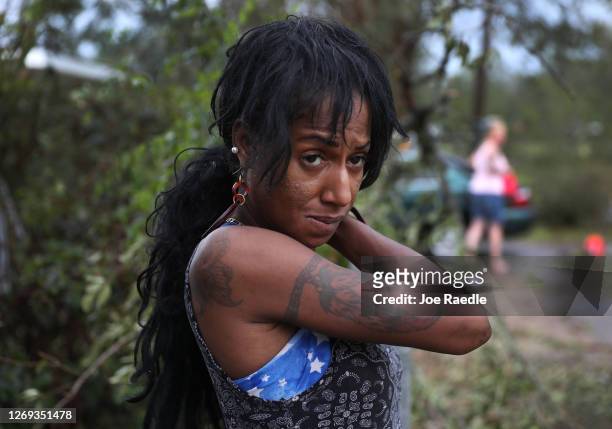 Dewayna Jordan stands in the front yard of her home after Hurricane Laura passed through the area on August 28, 2020 in Lake Charles, Louisiana ....