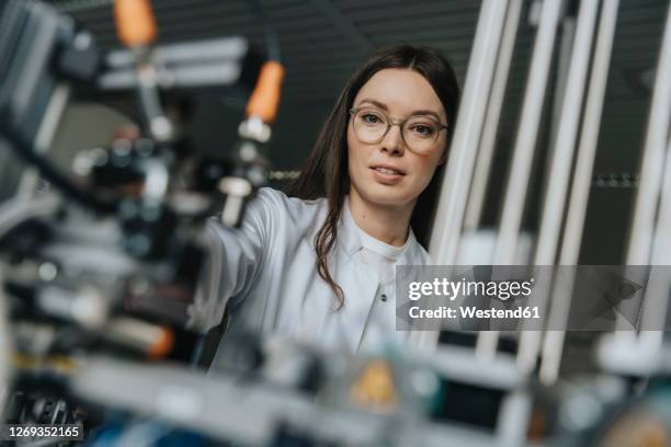 close-up of female scientist examining equipment in laboratory at factory - groundbreaking female scientists stock pictures, royalty-free photos & images