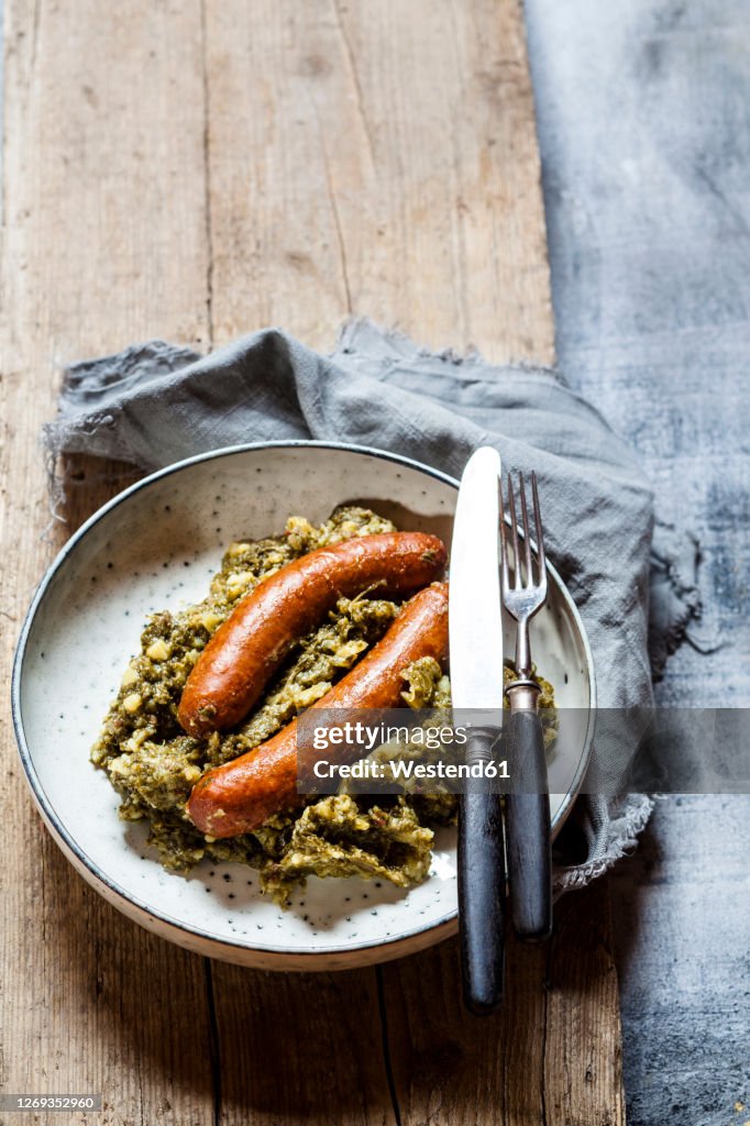 Plate of smoked sausages with kale