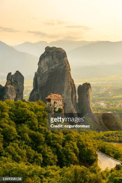 meteora monasteries at sunset, greece - meteora greece stock pictures, royalty-free photos & images