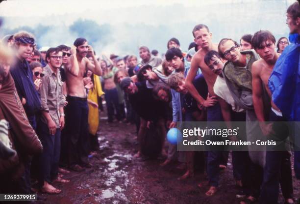 Crowd waiting for people to jump into the mud at Woodstock Music Festival, Bethel, New York, 15th-18th August 1969.