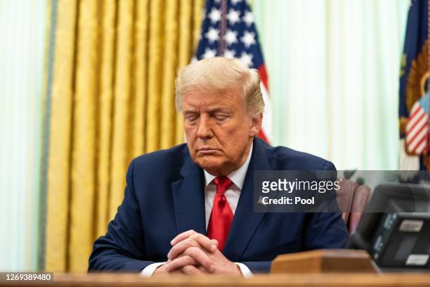 President Donald Trump participates in a prayer during an event in the Oval Office of the White House August 28, 2020 in Washington, DC. President...