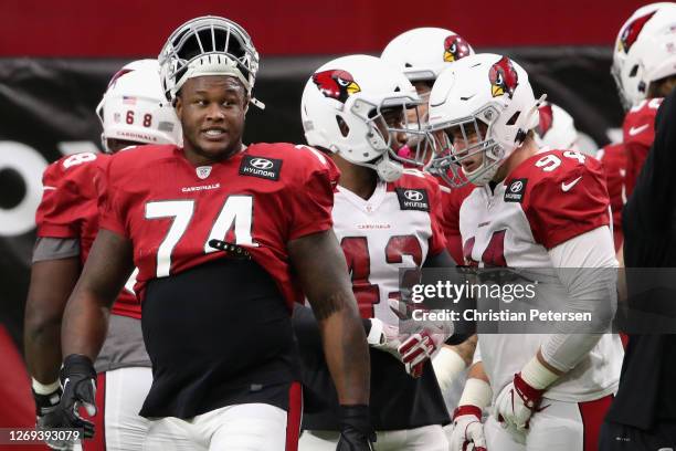 Offensive tackle D.J. Humphries of the Arizona Cardinals talks with defensive end Zach Allen during the Red & White Practice at State Farm Stadium on...