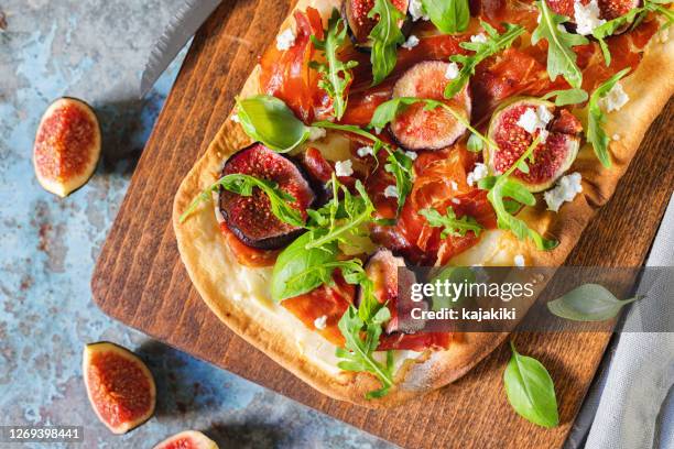 homemade pizza with figs, prosciutto,arugula and goat cheese - flatbread stock pictures, royalty-free photos & images