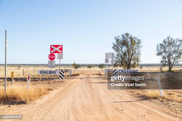 dirt road going through a railway crossing in the dry, drought area of australia - crossing road stock pictures, royalty-free photos & images