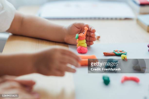 hands of an anonymous girl making plasticine figurines, art and craft concept - child's play clay stock pictures, royalty-free photos & images