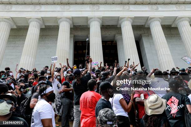 Protesters stand on the Lincoln Memorial during the Commitment March on August 28, 2020 in Washington, DC. Rev. Al Sharpton and the National Action...