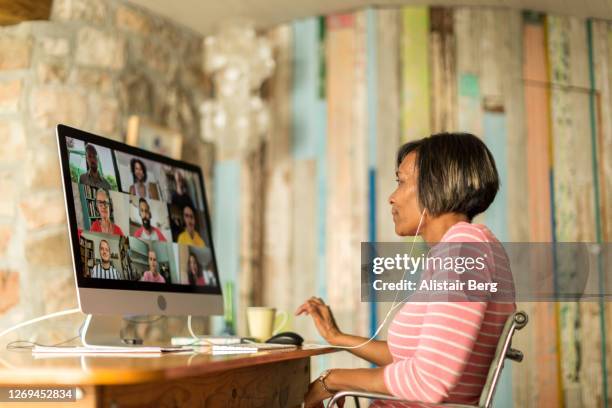 mature woman on video call from home during the covid lockdown - house remote location stock pictures, royalty-free photos & images