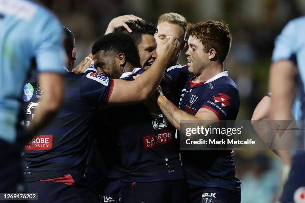 Matt Toomua of the Rebels celebrates scoring a try with team mates during the round nine Super Rugby AU match between the Waratahs and the Melbourne...