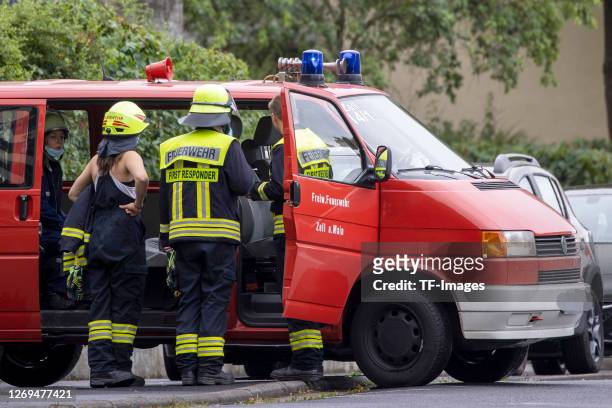 Firefighters and a special purpose vehicles are seen after a fire in an apartment building on August 22, 2020 in Veitshoechheim, Germany.