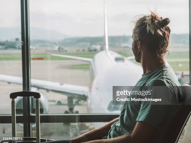 man in airport waiting for departure - zurich airport stock pictures, royalty-free photos & images