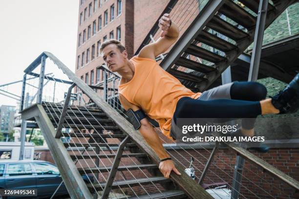 caucasian young man doing urban parkour - free running stock pictures, royalty-free photos & images