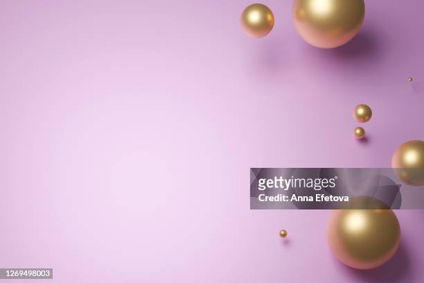 golden speres on pastel pink background - metalic make up stock pictures, royalty-free photos & images