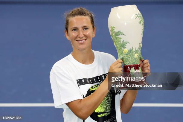 Victoria Azarenka of Belarus poses with the winner's trophy during the Western & Southern Open at the USTA Billie Jean King National Tennis Center on...