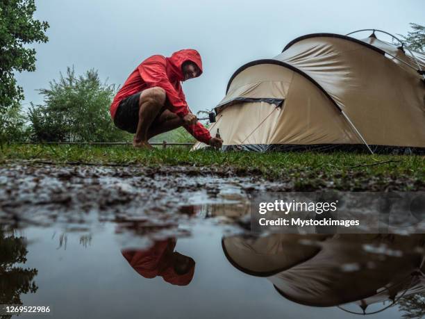 man caught in a rainstorm while camping - puddle stock pictures, royalty-free photos & images
