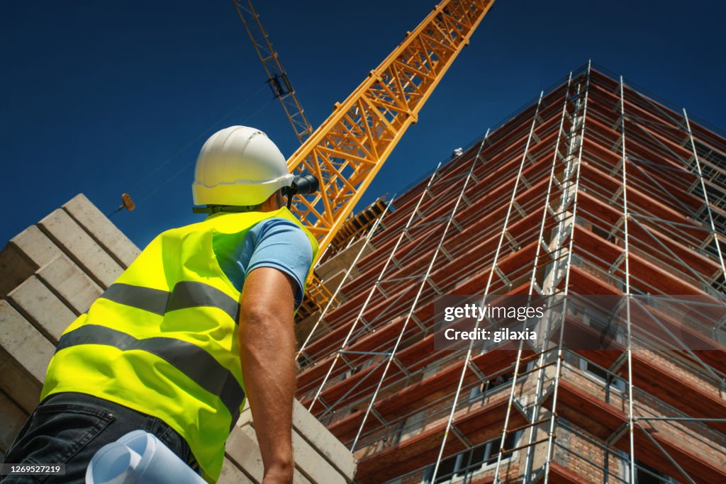 Construction engineer supervising building process