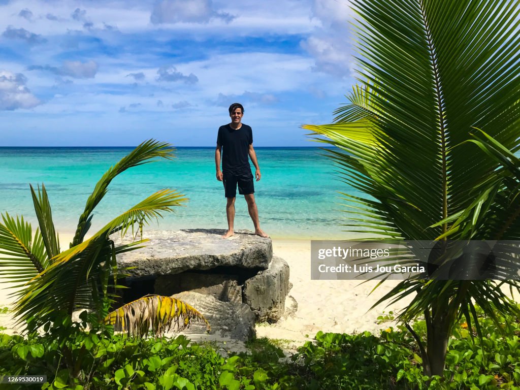 Soaked young man in idyllic beach