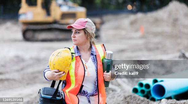 mature woman working at construction site, on break - hispanic construction worker stock pictures, royalty-free photos & images