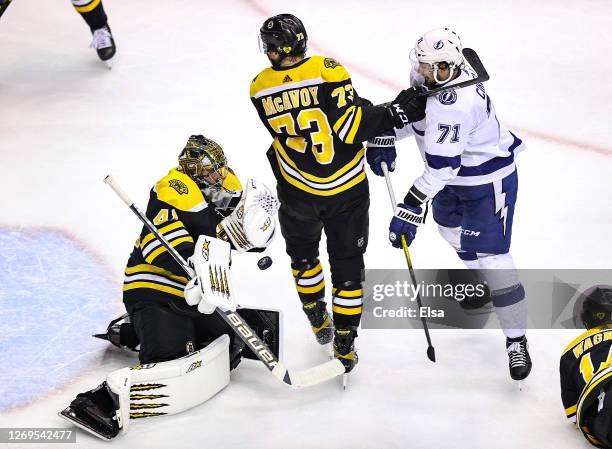 Jaroslav Halak of the Boston Bruins stops a shot as teammate Charlie McAvoy defends Anthony Cirelli of the Tampa Bay Lightning during the second...