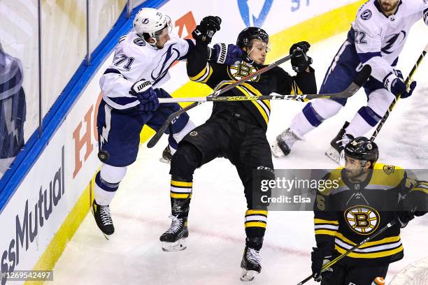 Charlie McAvoy of the Boston Bruins is checked by Anthony Cirelli of the Tampa Bay Lightning during the second period in Game Four of the Eastern...