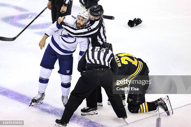 Nick Ritchie of the Boston Bruins fights Barclay Goodrow of the Tampa Bay Lightning during the third period in Game Four of the Eastern Conference...