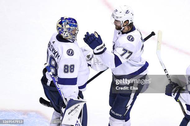 Andrei Vasilevskiy and Victor Hedman of the Tampa Bay Lightning celebrate their teams 3-1 victory against the Boston Bruins in Game Four of the...