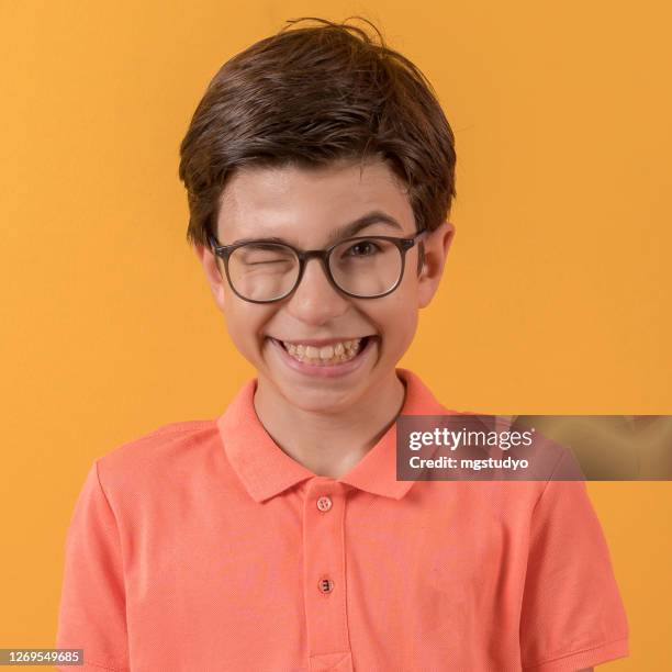 portrait of funny naughty boy keeping eyes closed. - student coloured background stock pictures, royalty-free photos & images