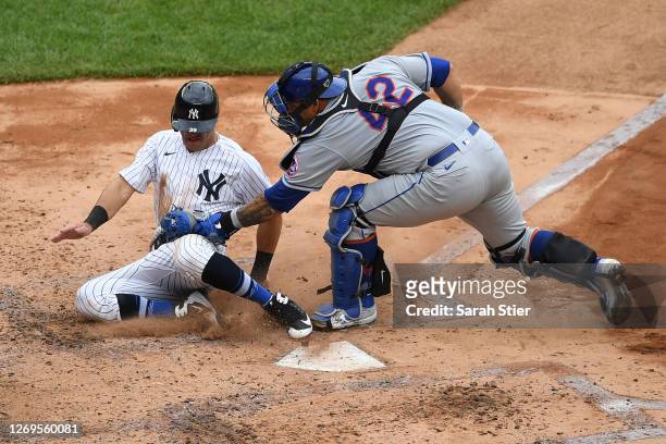 Wilson Ramos of the New York Mets tags out Mike Tauchman of the New York Yankees at home during the fourth inning at Yankee Stadium on August 29,...