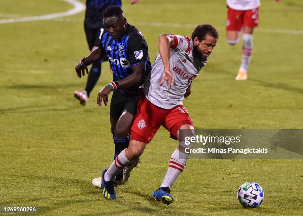 Victor Wanyama of the Montreal Impact challenges Nick DeLeon of Toronto FC during the second half of the MLS game at Saputo Stadium on August 28,...