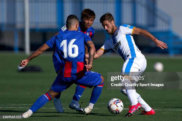 Ruben Perez of CD Leganes competes for the ball with Roberto Olabe of SD EIbar during the pre-season friendly match between Leganes and Eibar at...