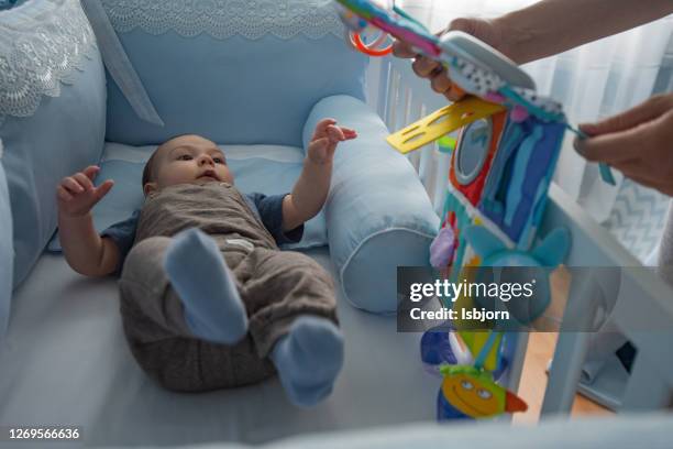 cute baby looking at his mother. - lullaby stock pictures, royalty-free photos & images