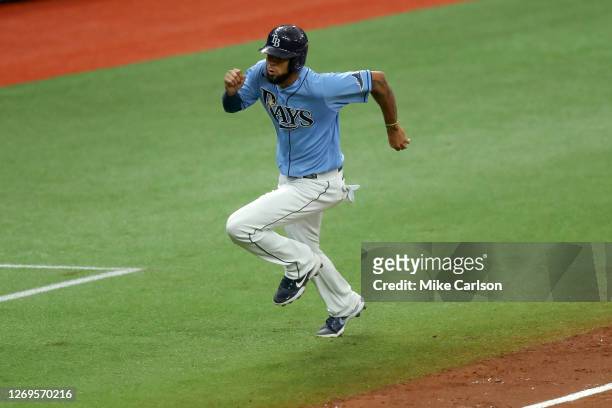 Jose Martinez of the Tampa Bay Rays comes in to score against the Toronto Blue Jays in the fifth inning of a baseball game at Tropicana Field on...