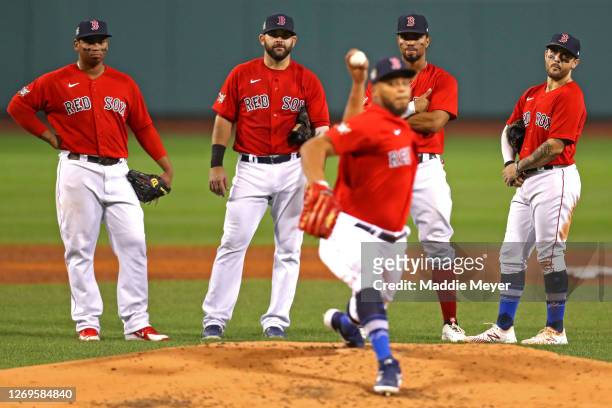 From left, Rafael Devers, Mitch Moreland, Xander Bogaerts, and Michael Chavis watch Darwinzon Hernandez warm up during the third inning against the...
